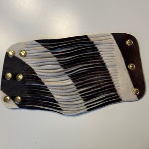 Black and white cowhide fur cuff bracelet.  5 inches wide. Snap closure